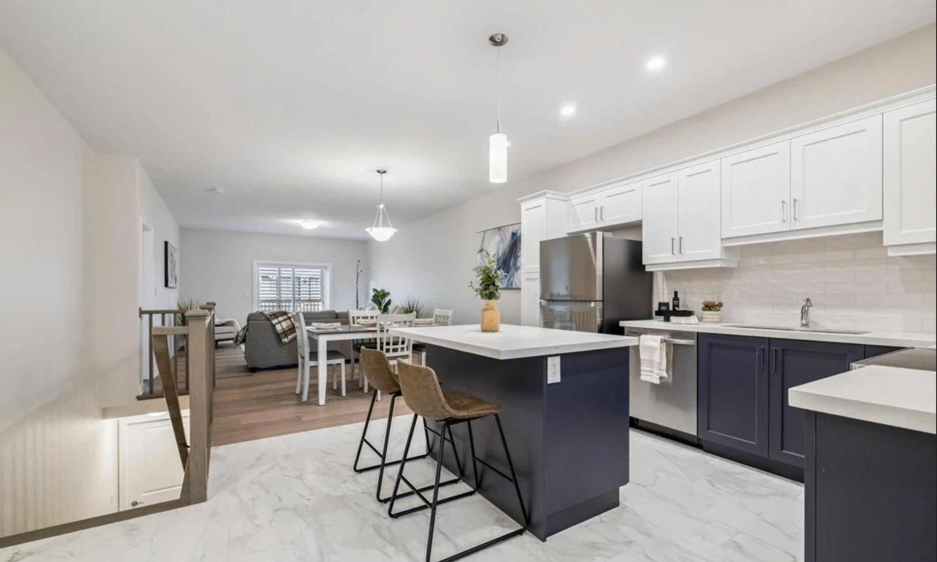 Open-concept kitchen with quartz counters and quality cabinetry inside a Hansler Village bungalow